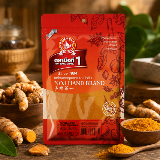 Red package of No. 1 Hand Brand with turmeric roots and powder on a wooden surface