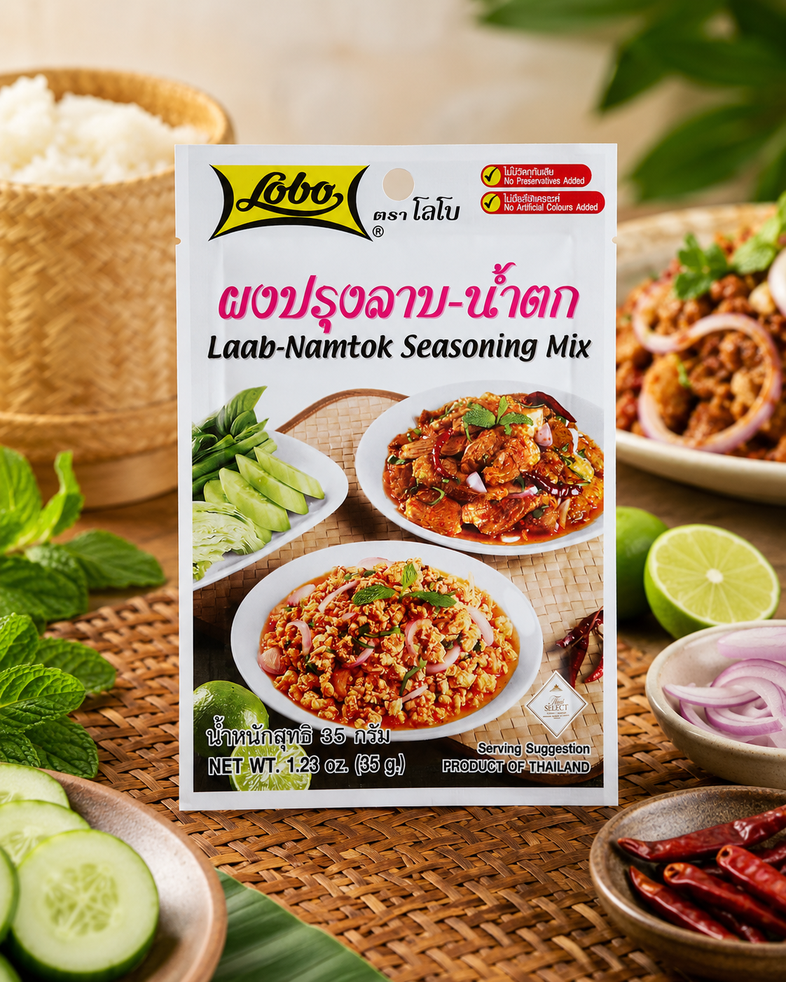 A package of Libao Laab-Namtok Seasoning Mix is centered on a woven mat, surrounded by Thai food ingredients and prepared dishes including rice, cucumbers, lime, red onions, and dried red chilies.