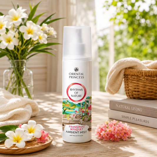 Oriental Princess ambient mist spray on a table with flowers and books in the background