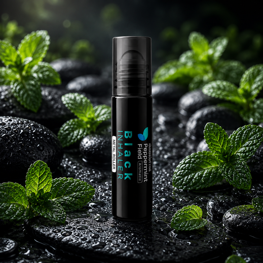 Black inhaler with green text on a dark surface with mint leaves